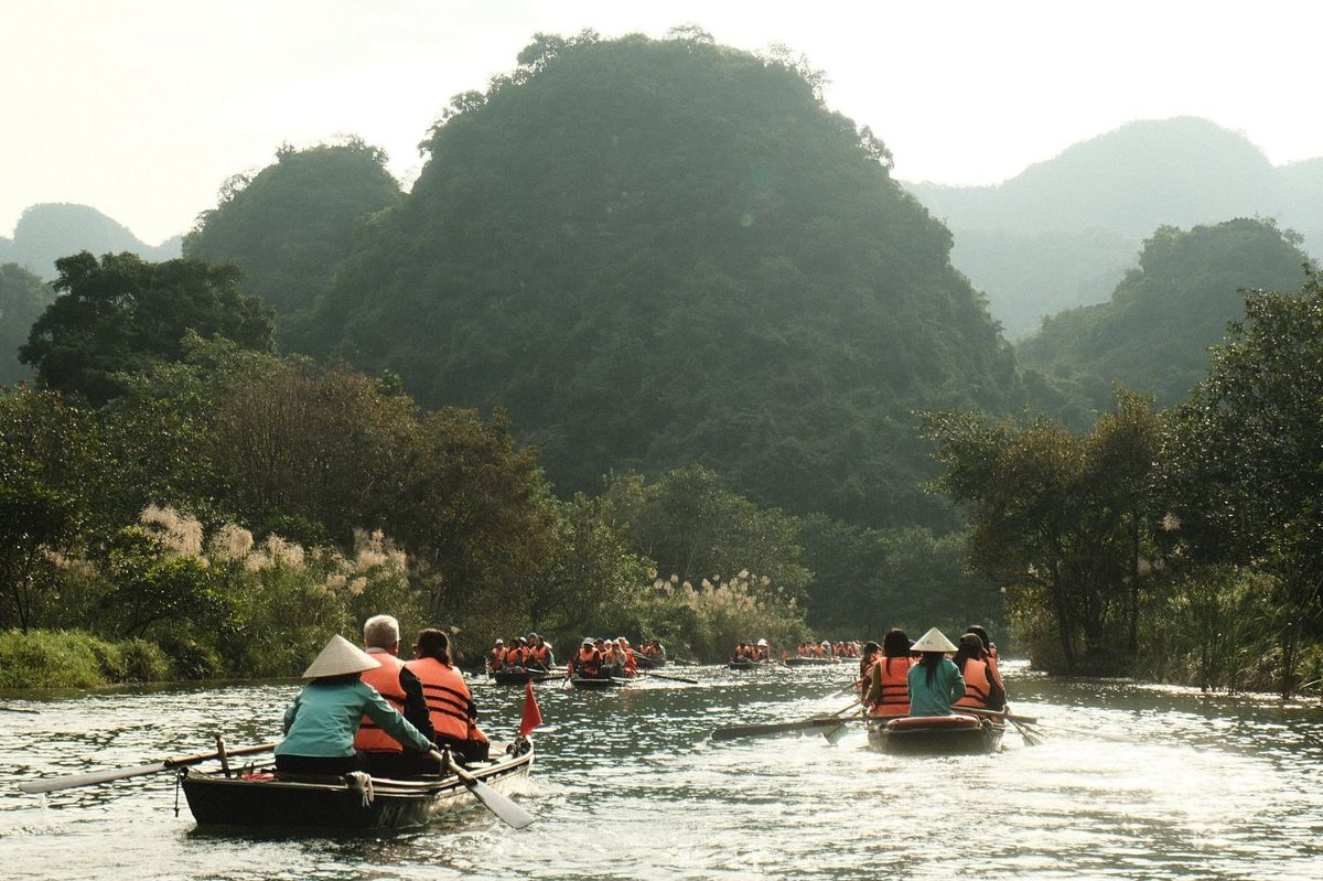 Boats winding through the Trang An valleys